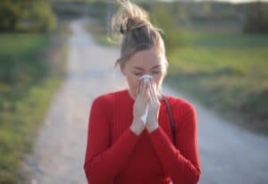 ALEX test Synevo Bulgaria a female wearing red blouse who is having seasonal allergic reactions